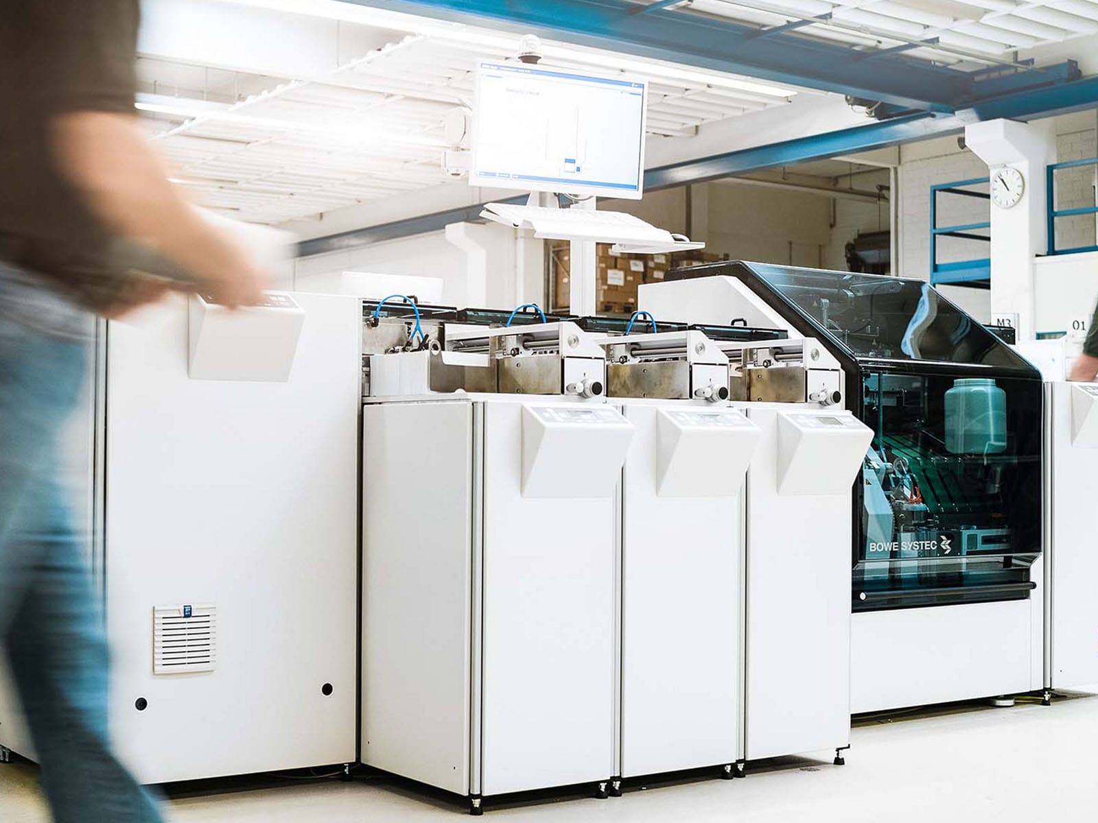 Modern Laboratory Equipment in Use Workers operating advanced machinery in a laboratory setting